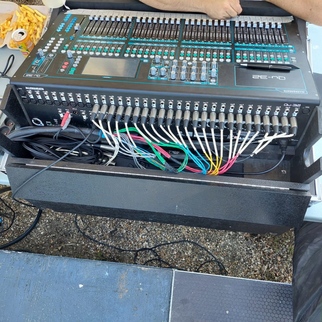 Installation de matériel de sonorisation pour la fête de la musique à Coignières, avec une table de mixage et des câbles.