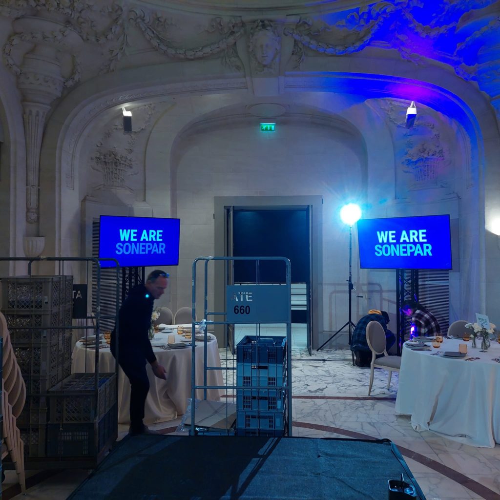 Préparatifs d'un événement au Pavillon Dauphine, avec matériel de sono et éclairage en place.