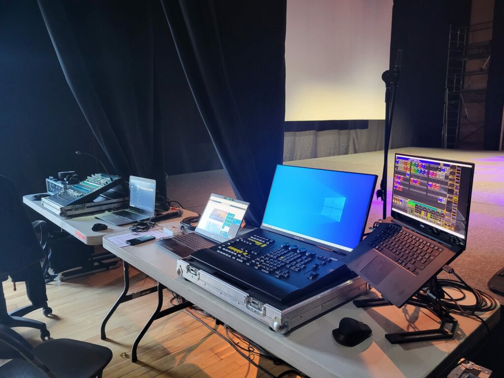 Poste de contrôle audio et éclairage au Théâtre Michel Audiard de Chevreuse, dirigé par Paul Dureau pour un événement.